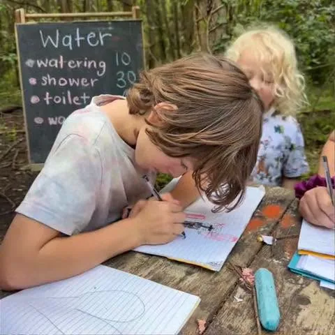 Student working in a notebook outdoors